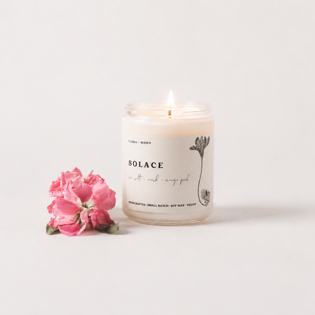 Candle with a pink flower on a white background