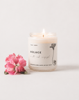 Candle with a pink flower on a white background